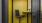 Yellow phone booth room with black chair 